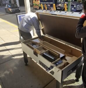 Specialists moving and installing a Tornado foosball table in a commercial venue