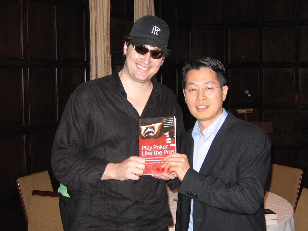 Phil Hellmuth signing his book Play Poker Like the Pros at a corporate poker event in NYC