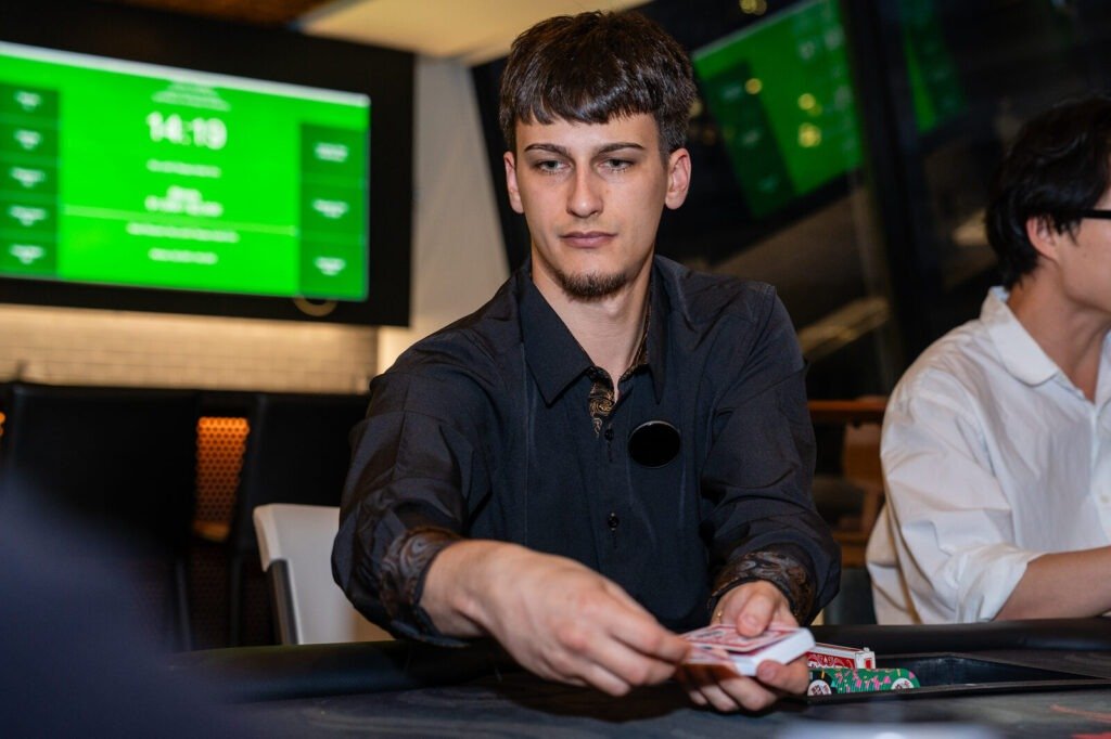Professional Texas Hold'em dealer running a poker table rental at a corporate event in NJ
